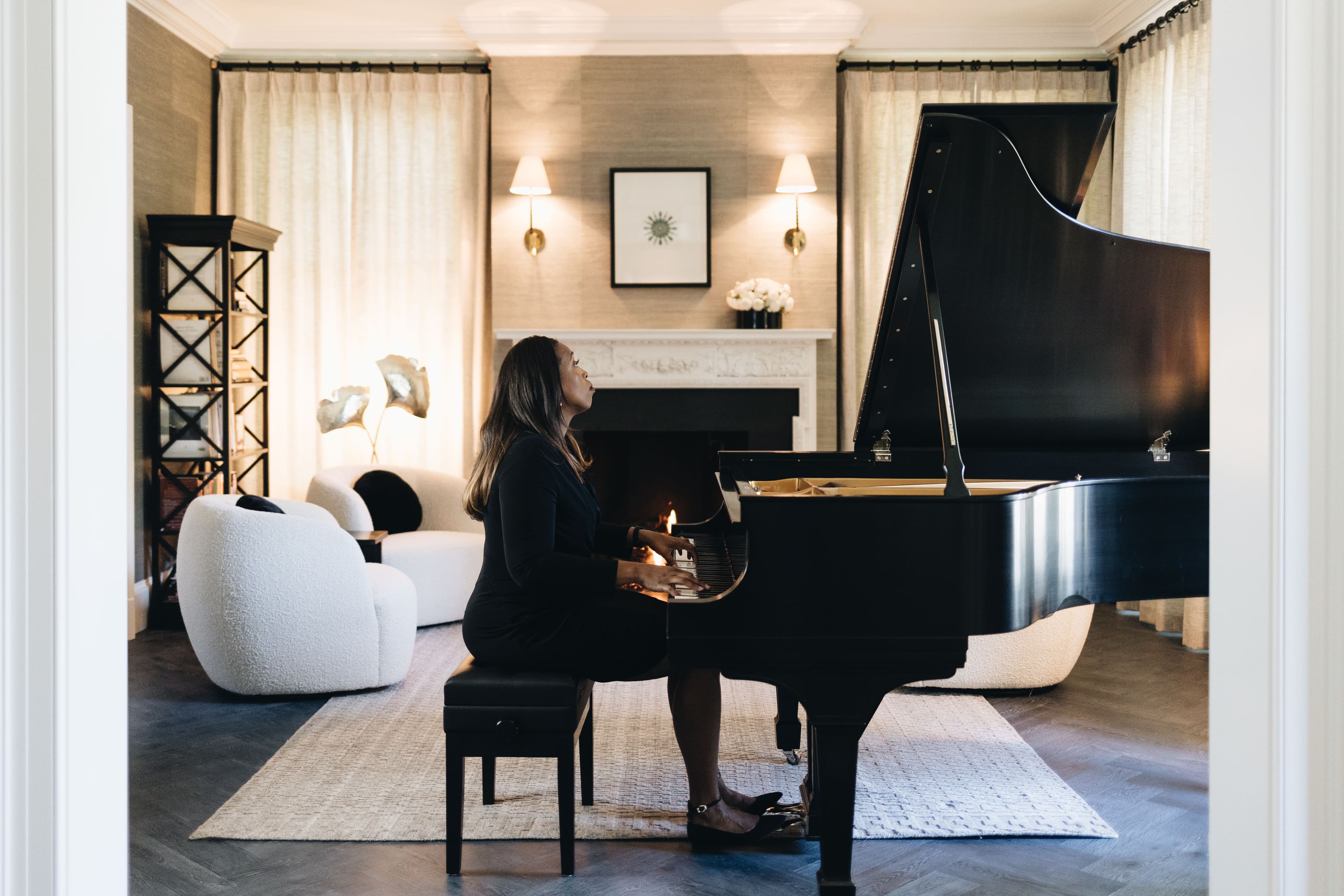 Faith playing grand piano in an elegant room
