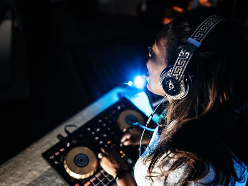 Close-up of L8DY8 mixing with crystal headphones