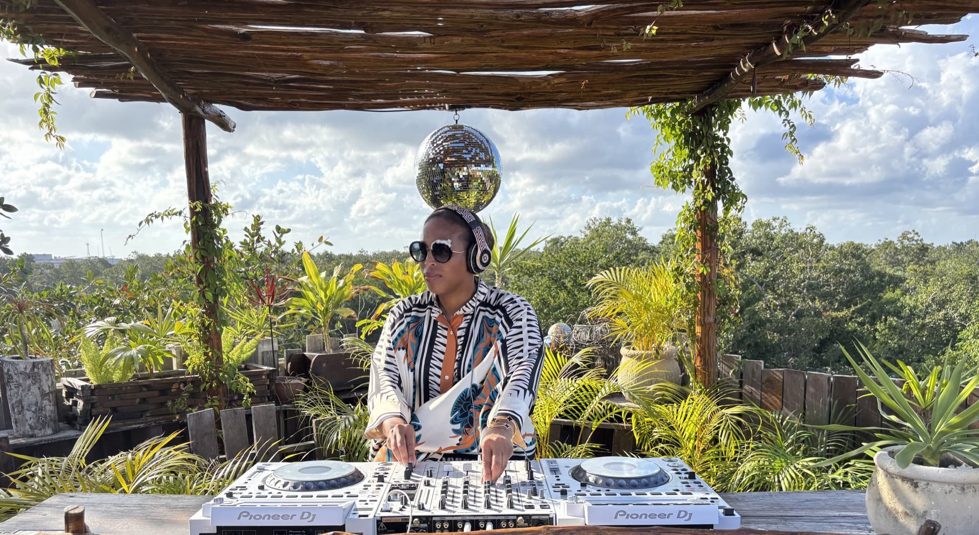 DJ L8DY8 performing on a rooftop in Tulum